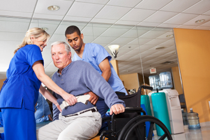 Preventing Pressure Sores woman helping man out of wheelchair