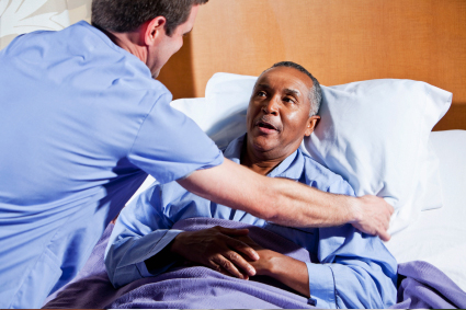 man being comforted in hospital bed